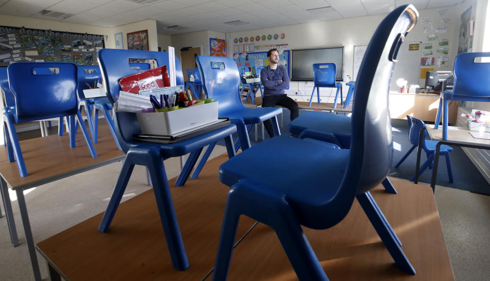 Simon Cotterill, Head Teacher of Manor Park School and Nursery in Knutsford Cheshire, sits in an empty classroom, the day after Prime Minister Boris Johnson put the UK in lockdown to help curb the spread of the coronavirus.