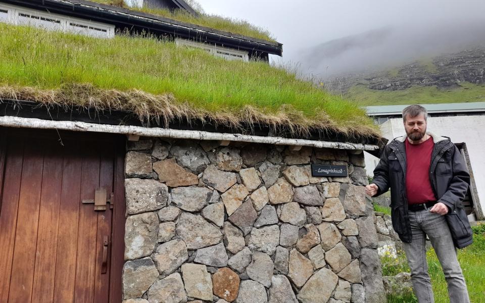 Guide shows a traditional croft house in Bøur - Mark Stratton