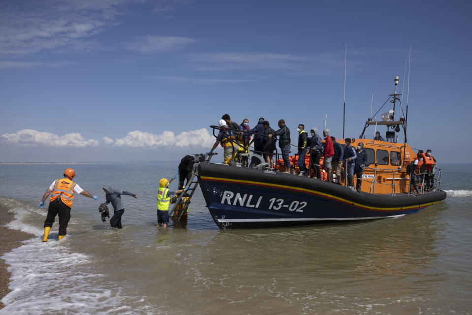 <p>DUNGENESS, ENGLAND - AUGUST 04: A group of around 40 migrants arrive via the RNLI (Royal National Lifeboat Institution) on Dungeness beach on August 04, 2021 in Dungeness, England. UK Home Secretary Priti Patel recently said that the government would seek to criminalise irregular migration, accusing people smugglers of "exploiting our asylum system to bring in economic migrants and people that, quite frankly, are circumventing our legal migration routes." (Photo by Dan Kitwood/Getty Images)</p>
