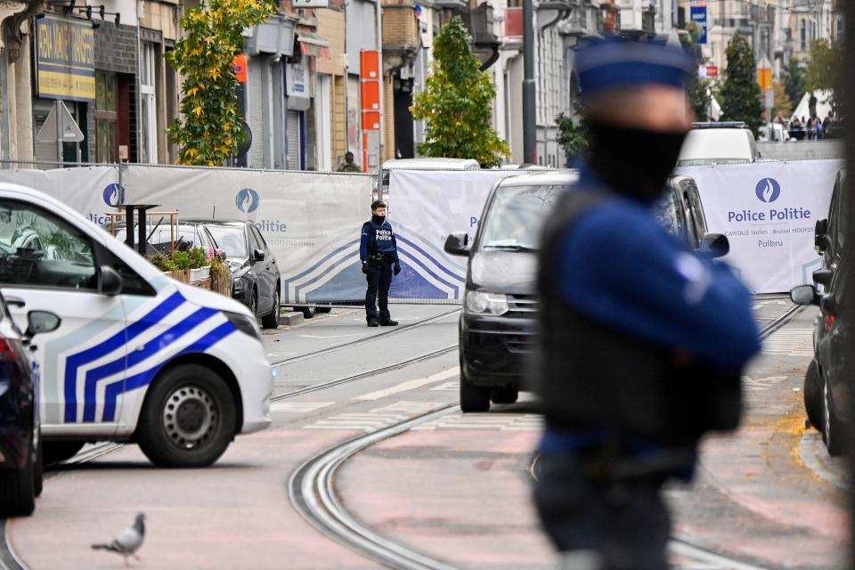 Police officers stand guard in front of the house where the suspected perpetrator of the attack was shot dead (AFP via Getty Images)