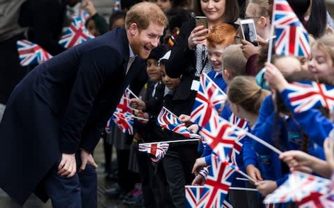 Prince Harry beams as he chats to children in Birmingham - Credit: Heathcliff O'Malley for The Telegraph 