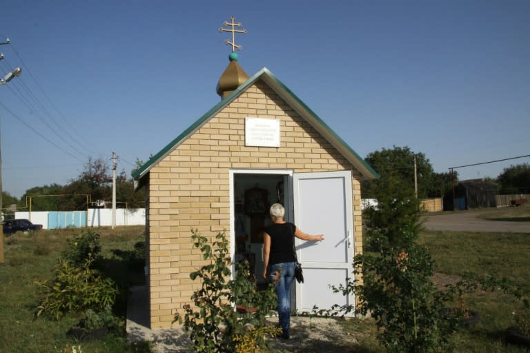 Tetyana, a resident of the small village of Peremozhne, in the Lugansk region of Ukraine, enters a small church