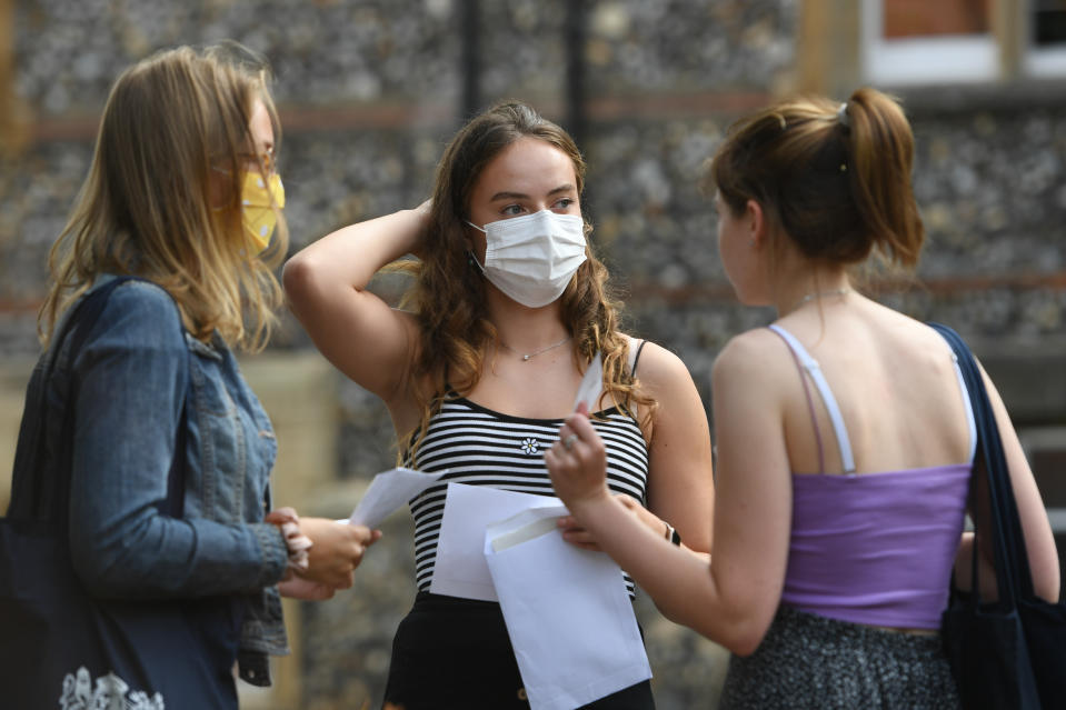 Benita Stipp (centre) and Mimi Ferguson (left) react as students at Norwich School, Norwich, receive their A-Level results.