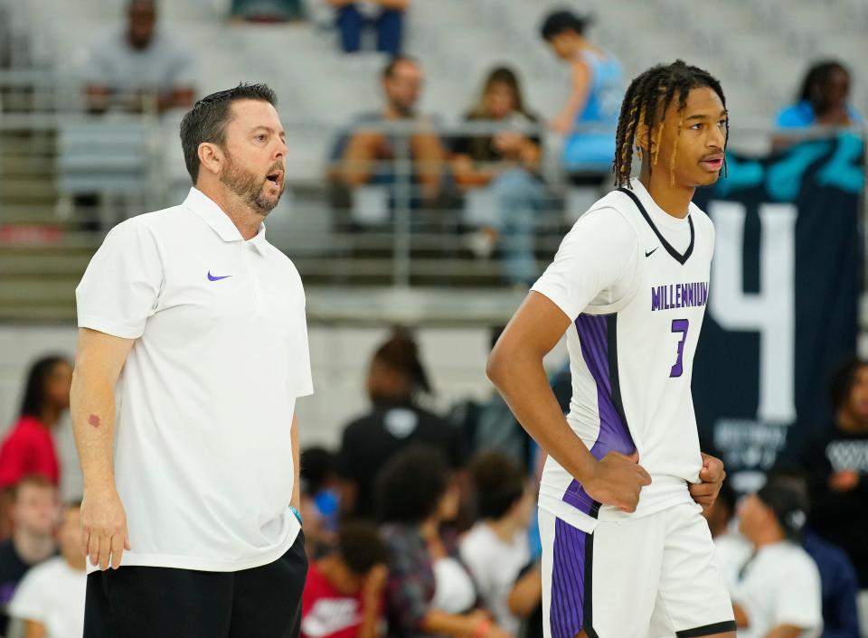 Millennium head coach Ty Amundsen (left) talks with forward Cameron Holmes (3) during the Section 7 Basketball Tournament at State Farm Stadium in Glendale on June 23, 2023.