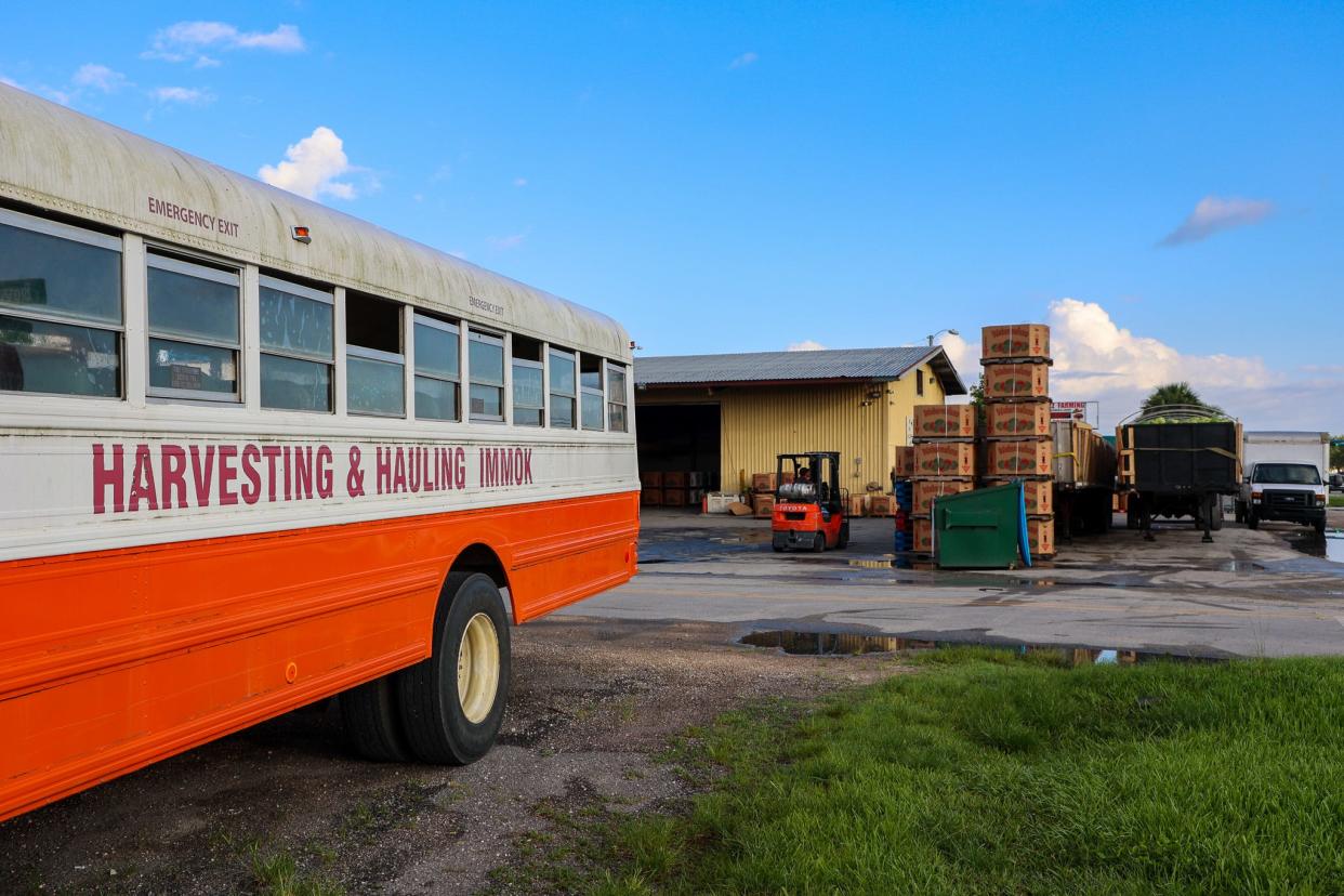 A bus used to transport farm workers sits outside a produce packing plant in Immokalee, Florida.