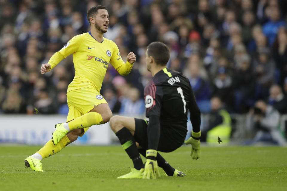 Chelsea's Eden Hazard, left, scores past Brighton goalkeeper Mathew Ryan his side's second goal during the English Premier League soccer match between Brighton and Hove Albion and Chelsea at the Amex Stadium in Brighton, England, Sunday, Dec. 16, 2018. (AP Photo/Matt Dunham)