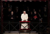 Pope Francis leads the Via Crucis (Way of the Cross) torchlight procession celebrated in front of the Colosseum on Good Friday in Rome, Friday, April 18, 2014. The evening Via Crucis procession at the ancient amphitheater is a Rome tradition that draws a large crowd of faithful, including many of the pilgrims who flock to the Italian capital for Holy Week ceremonies before Easter Sunday. (AP Photo/Andrew Medichini)