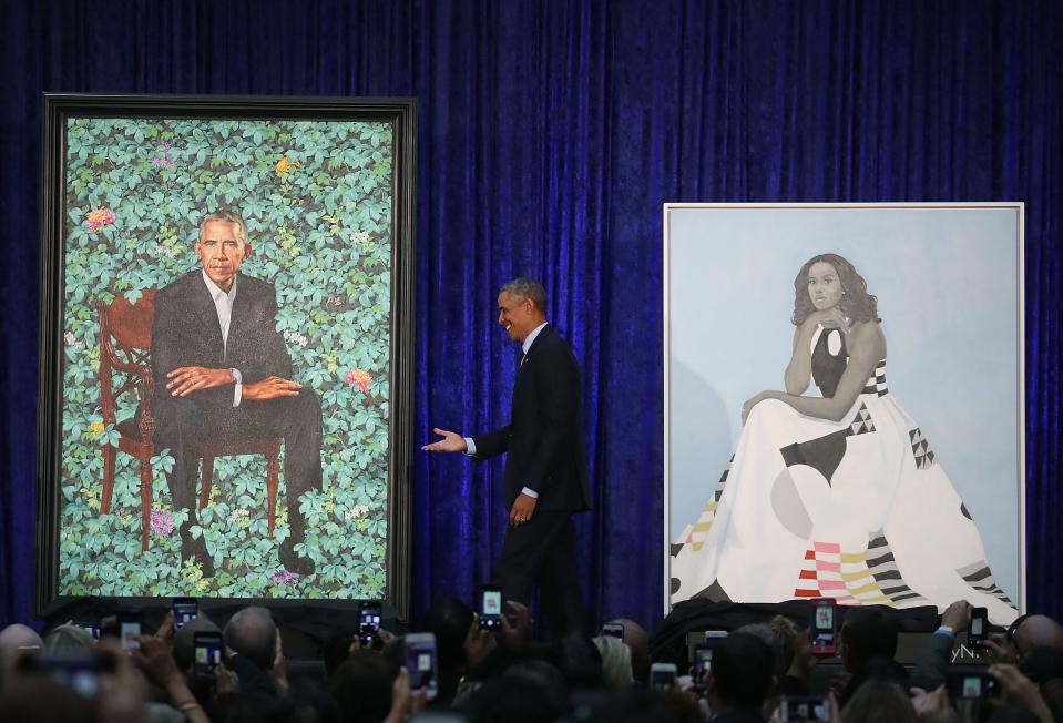 Former President Barack Obama stands with his and former first lady Michelle Obama's newly unveiled portraits at the Smithsonian's National Portrait Gallery, on Feb.12, 2018 in Washington, DC.