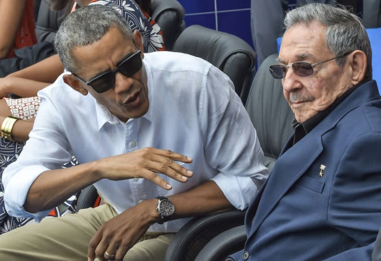 US President Barack Obama speaks next to Cuban President Raul Castro (R) during a Major League baseball exhibition game at the Latinoamericano stadium in Havana