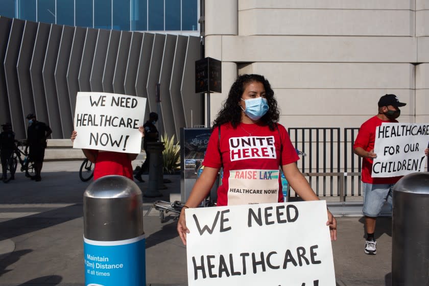 LOS ANGELES, CA - SEPTEMBER 03: Elizabeth Mejia, an employee at LAX for 8 years and server at one of the airport's restaurants, protests outside of outside of Tom Bradley International Airport at LAX on Thursday, Sept. 3, 2020 in Los Angeles, CA. The employees, many whom work in the airport's restaurants, are calling for healthcare coverage for employed and recently laid off workers. Most employees are people of color, who have been disproportionately affected by the COVID-19 pandemic. (Gabriella Angotti-Jones / Los Angeles Times)