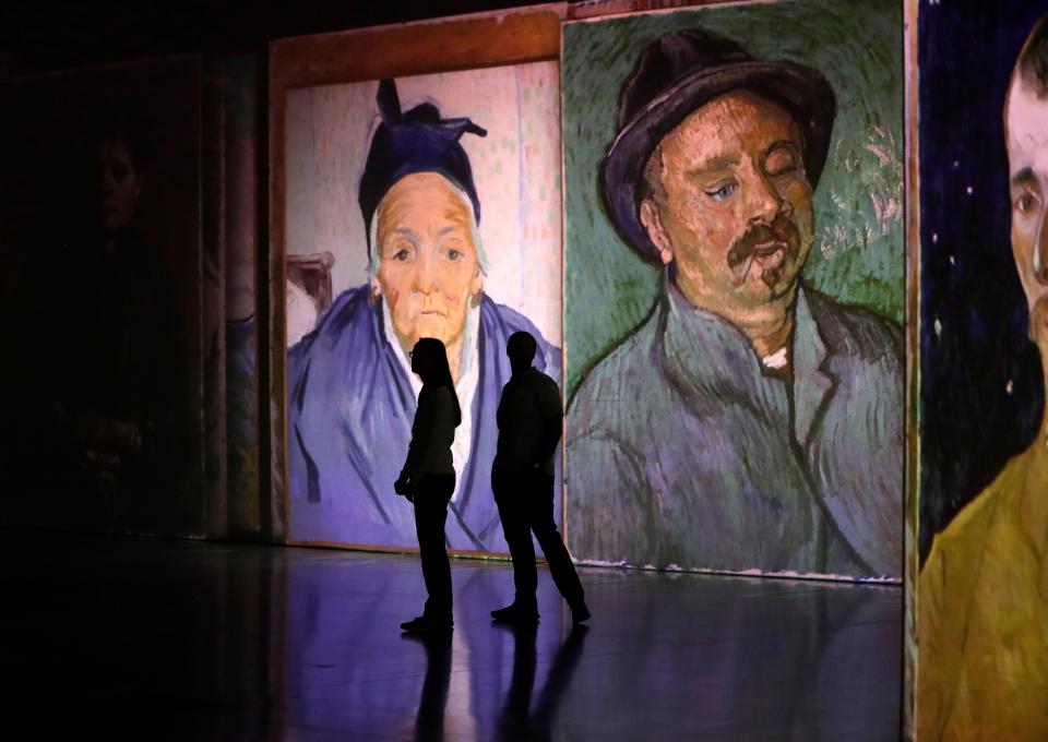 Guests explore 'Beyond Van Gogh: The Immersive Experience' during a preview event.