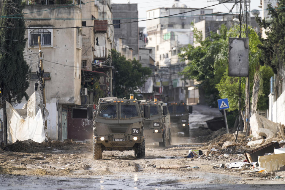 Israeli military vehicles are seen in the town of Tulkarem, West Bank, Wednesday, Nov. 22, 2023. The Palestinian Health Ministry said the Israeli military killed six Palestinians, five of them militants, during a raid that sparked an hourslong firefight with militants in a flashpoint refugee camp in the northern city of Tulkarem. (AP Photo/Majdi Mohammed)