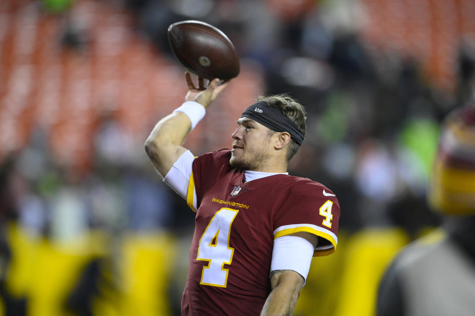 Washington Football Team quarterback Taylor Heinicke (4) toss the game ball to fans at the end of an NFL football game against the Seattle Seahawks, Monday, Nov. 29, 2021, in Landover, Md. Washington won 17-15. (AP Photo/Nick Wass)