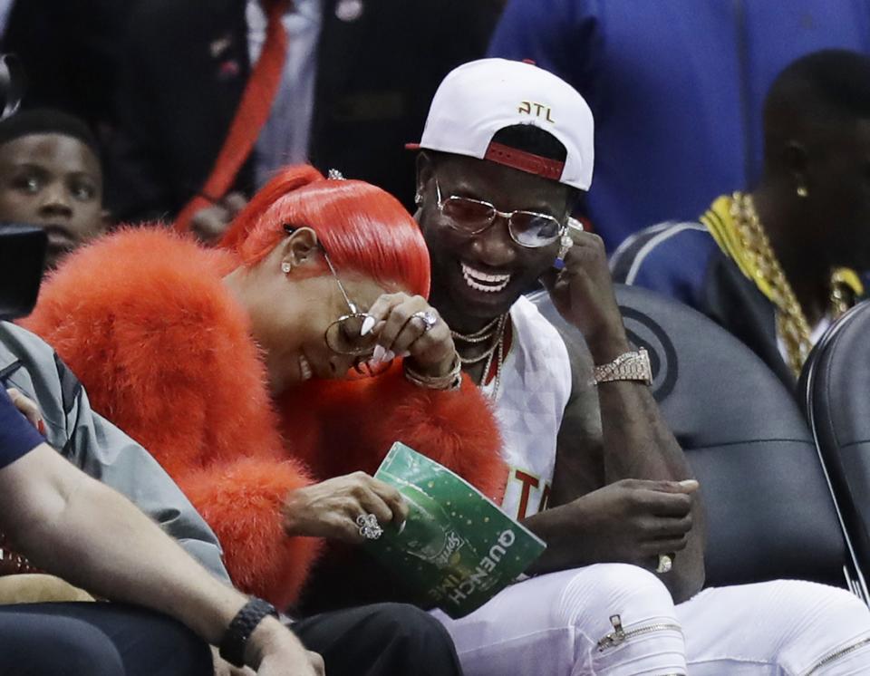 Hip-hop artist Gucci Mane (right) laughs with Keyshia Ka'oir after he proposed to her in the fourth quarter of Hawks-Pelicans on Tuesday. (AP)