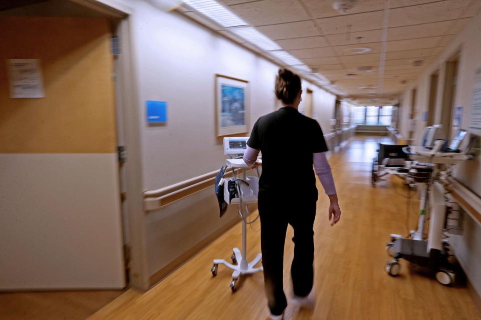 A nurse prepares to check patients vitals at  Ascension SE Wisconsin Hospital - St. Joseph Campus.