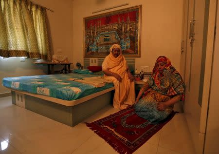 Zakia Jafri (L), whose late husband, a lawmaker for the Congress party which now sits in opposition, was hacked to death by a Hindu mob in riots, and her daughter-in law offer prayers inside her son's house in Surat, India, September 15, 2015. 2015. REUTERS/Amit Dave