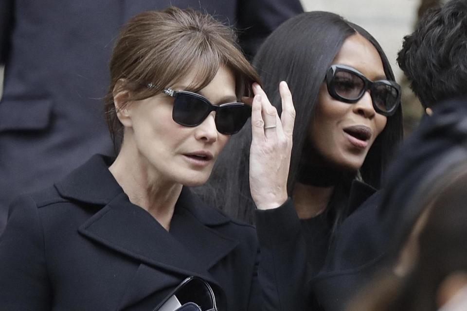 Carla Bruni and Naomi Campbell both wore black paired with dark sunglasses (AP)