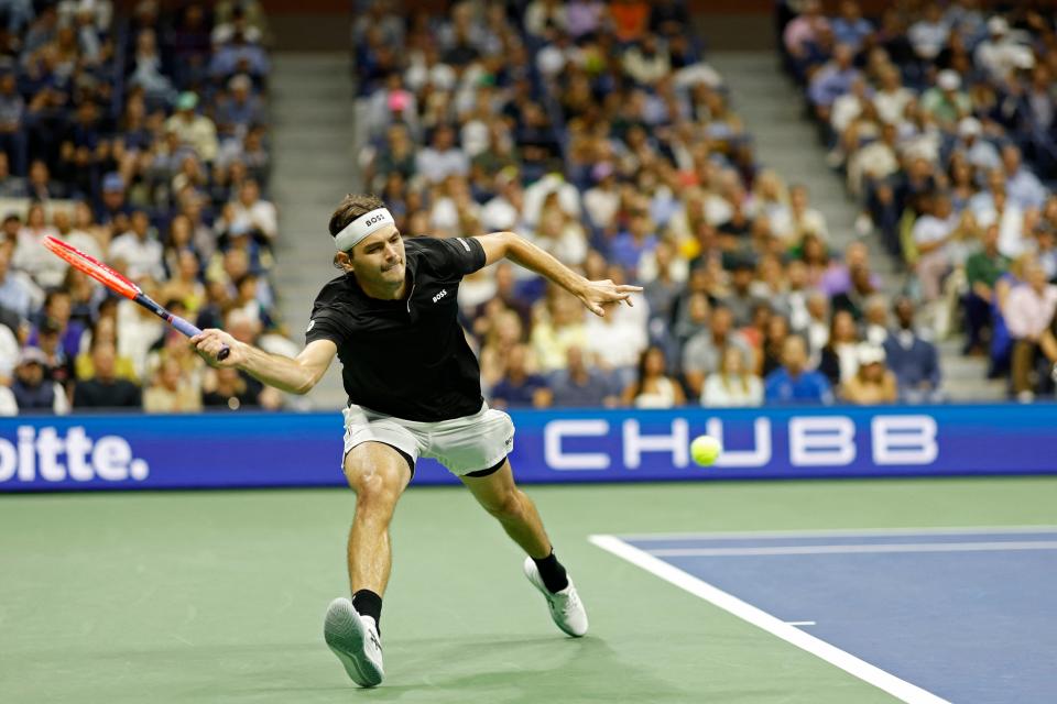 Sep 6, 2024; Flushing, NY, USA; Taylor Fritz (USA) reaches for a forehand against Frances Tiafoe (USA)(not pictured) in a men's singles semifinal of the 2024 U.S. Open tennis tournament at USTA Billie Jean King National Tennis Center.. Mandatory Credit: Geoff Burke-Imagn Images (USA TODAY Sports via Reuters Con)