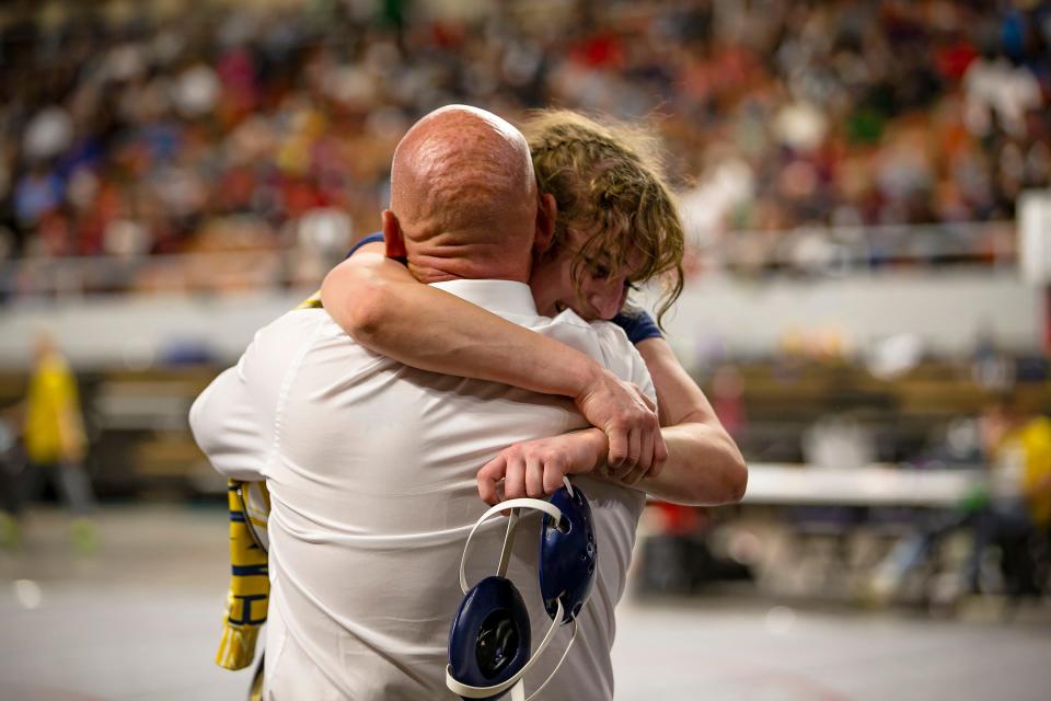 Casteel wrestler Camry Carter hugs her coach following a win during the AIA state wrestling championships in the Arizona Veterans Memorial Coliseum in Phoenix on Feb. 19, 2022. Monica D. Spencer/The Republic 6869573001