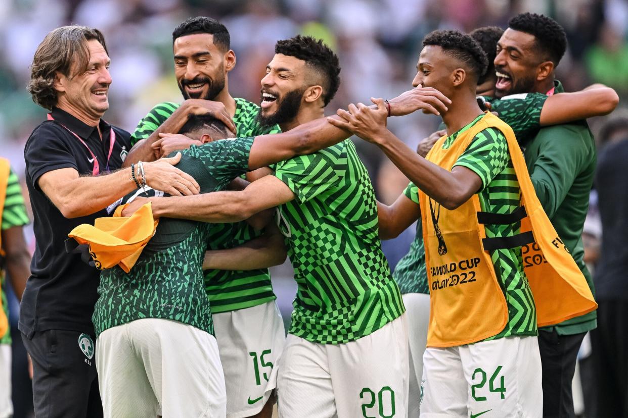 Saudi Arabia's players celebrate the victory during the FIFA World Cup Qatar 2022 Group C match between Argentina and Saudi Arabia at Lusail Stadium on November 22, 2022 in Lusail City, Qatar.