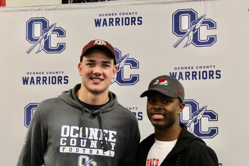 Oconee County's Darius Johnson (right) and Jake Johnson (left) signed to play football at Gardner-Webb and Texas A&M Wednesday morning.