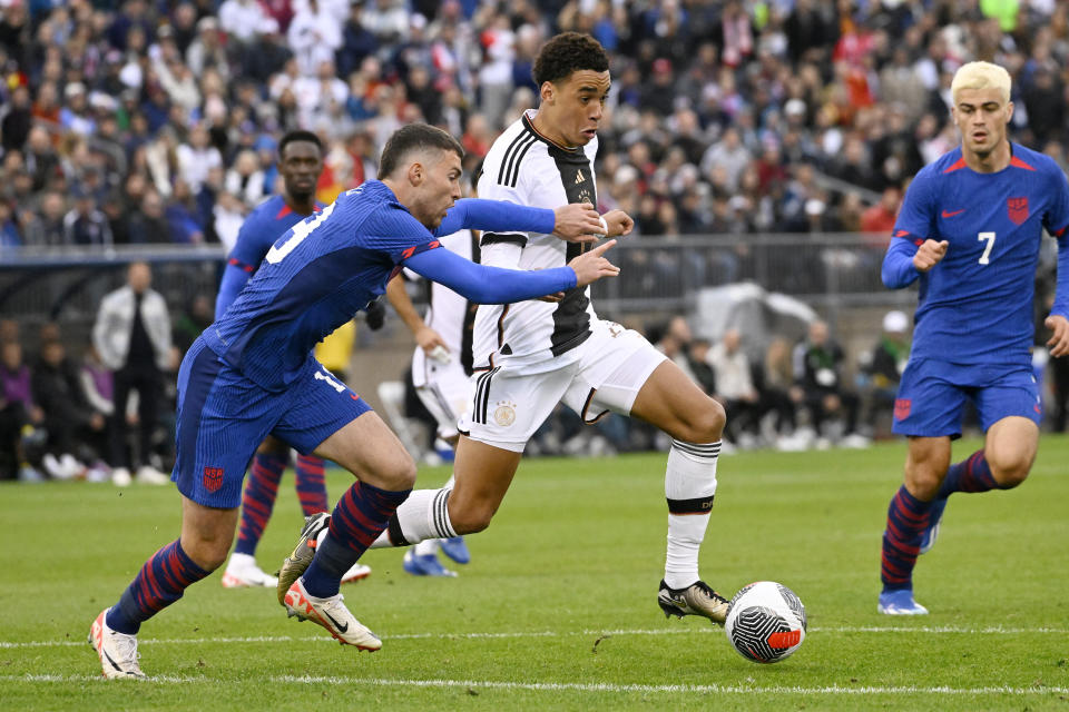 Germany's Jamal Musiala, right, dribbles the ball as United States' Joe Scally defends during an international friendly soccer match at Pratt & Whitney Stadium at Rentschler Field, Saturday, Oct. 14, 2023, in East Hartford, Conn. (AP Photo/Jessica Hill)