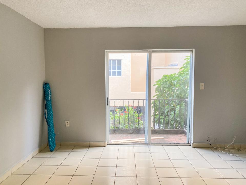 A view of the living room on the first floor of the Miami apartment shows the patio