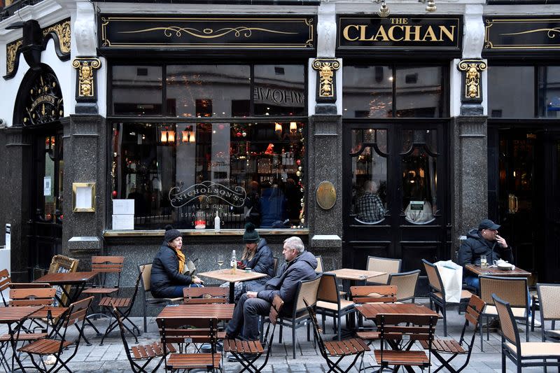 FILE PHOTO: Customers drink in an outdoor seating area of a pub, amidst the spread of the coronavirus disease (COVID-19) pandemic, London