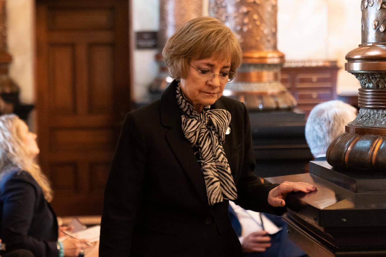 Sen. Beverly Gossage, R-Eudora, walks back to her seat during Wednesday's veto session at the Statehouse.