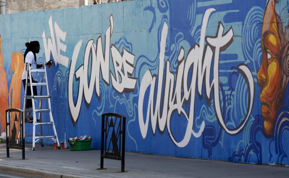 FILE - In this July 10, 2020, file photo, Artist Jimmy Baptiste works on a mural in Ottawa. 2020 is barely halfway over. That hasn't stopped many people from declaring the year canceled and wishing it would end. (Adrian Wyld/The Canadian Press via AP, File)