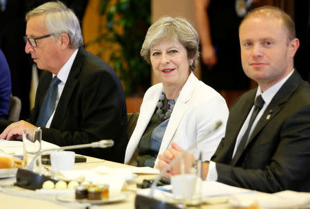 European Commission President Jean-Claude Juncker, British Prime Minister Theresa May (C), and Maltese Prime Minister Joseph Muscat take part in an EU summit in Brussels, Belgium October 20, 2017. REUTERS/Julien Warnand/Pool