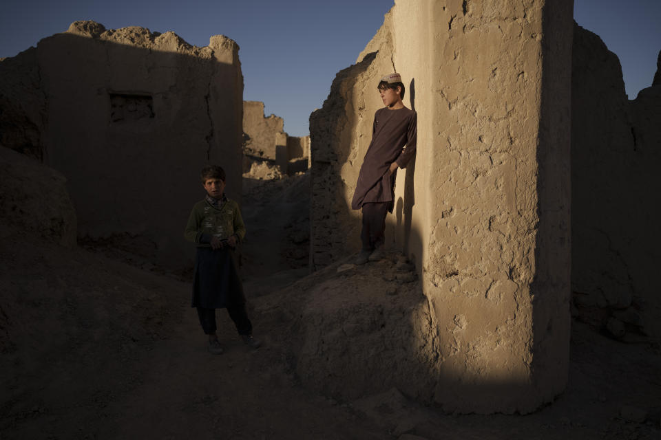 Afghan children stand among the ruins of houses destroyed by war in Salar village, Wardak province, Afghanistan, Tuesday, Oct. 12, 2021. In urban centers, public discontent toward the Taliban is focused on threats to personal freedoms, including the rights of women. In Salar, these barely resonate. The ideological gap between the Taliban leadership and the rural conservative community is not wide. Many villagers supported the insurgency and celebrated the Aug. 15 fall of Kabul which consolidated Taliban control across the country. (AP Photo/Felipe Dana)