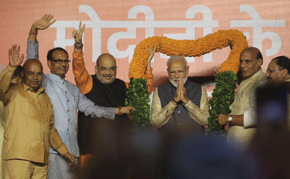 Bharatiya Janata Party (BJP) President Amit Shah, third left, Home Minister Rajnath Singh, second right, and other party leaders present a giant floral garland to Indian Prime Minister Narendra Modi at the party headquarters in New Delhi, India, Thursday, May 23, 2019. Indian Prime Minister Narendra Modi's party claimed it had won reelection with a commanding lead in Thursday's vote count, while the stock market soared in anticipation of another five-year term for the pro-business Hindu nationalist leader. (AP Photo/Manish Swarup)