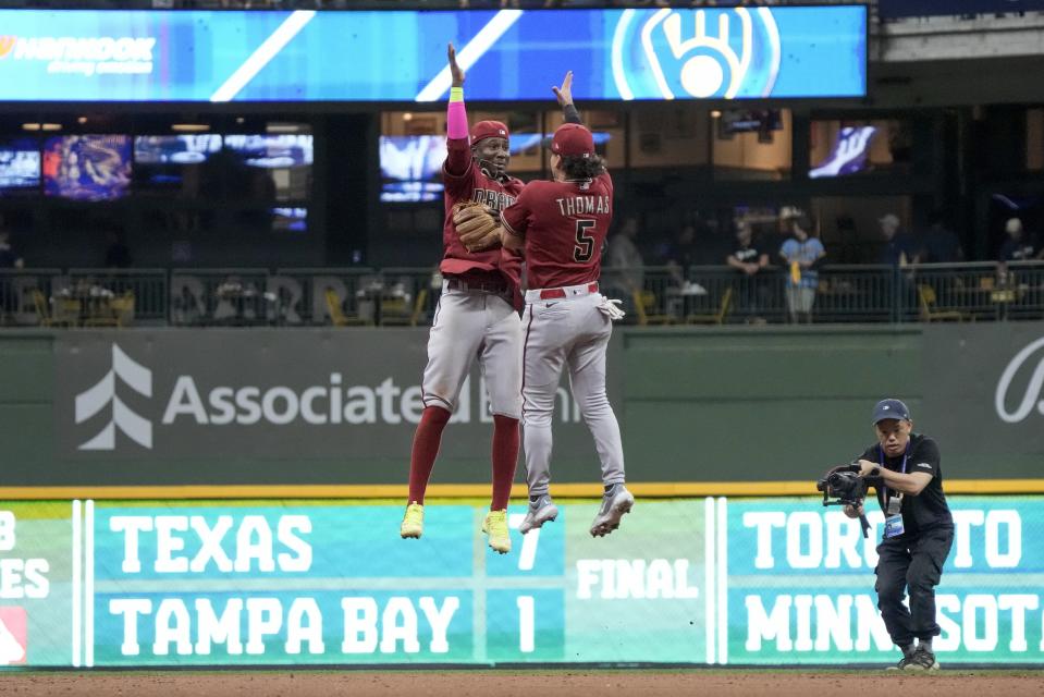 Arizona Diamondbacks' Geraldo Perdomo and Alek Thomas (5) celebrate after Game 2 of their National League wildcard baseball series against the Milwaukee Brewers Wednesday, Oct. 4, 2023, in Milwaukee. The Diamondbacks won 5-2 to win the series. (AP Photo/Morry Gash)