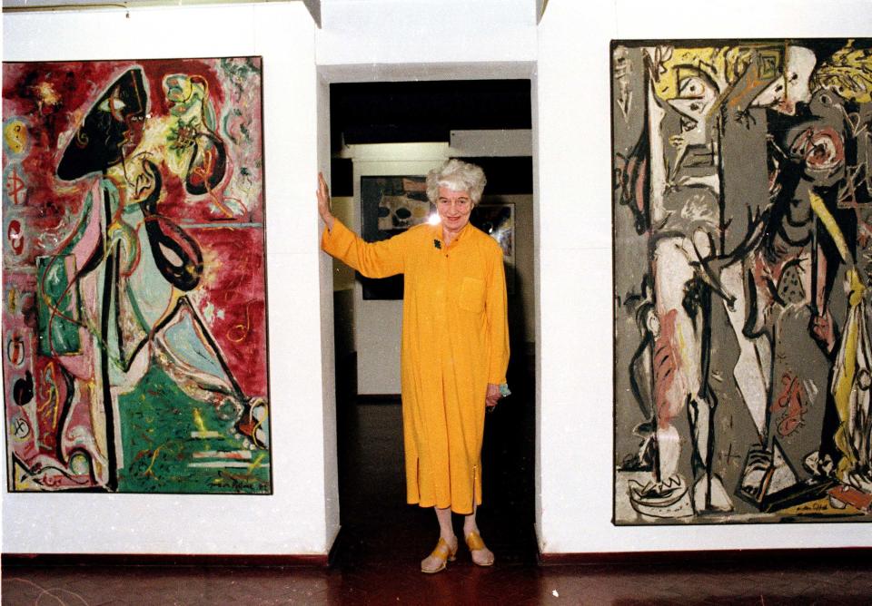 FILE - In this May 30, 1979, file photo, American art collector Peggy Guggenheim poses between early paintings by Jackson Pollock that are part of her modern art collection at her 18th century palace, Palazzo Venier dei Leoni, in Venice, Italy.  Pollock, who would have turned 100 in 2012, will have the anniversary of his birth observed with exhibitions, fundraisers and other events throughout the year.  (AP Photo/Jerry T. Mosey, File)