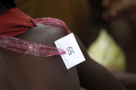 An identity number tag hangs around the neck of a migrant, who was found at sea on a boat, near Kanyin Chaung jetty after landing outside Maungdaw township, northern Rakhine state, Myanmar June 3, 2015. REUTERS/Soe Zeya Tun