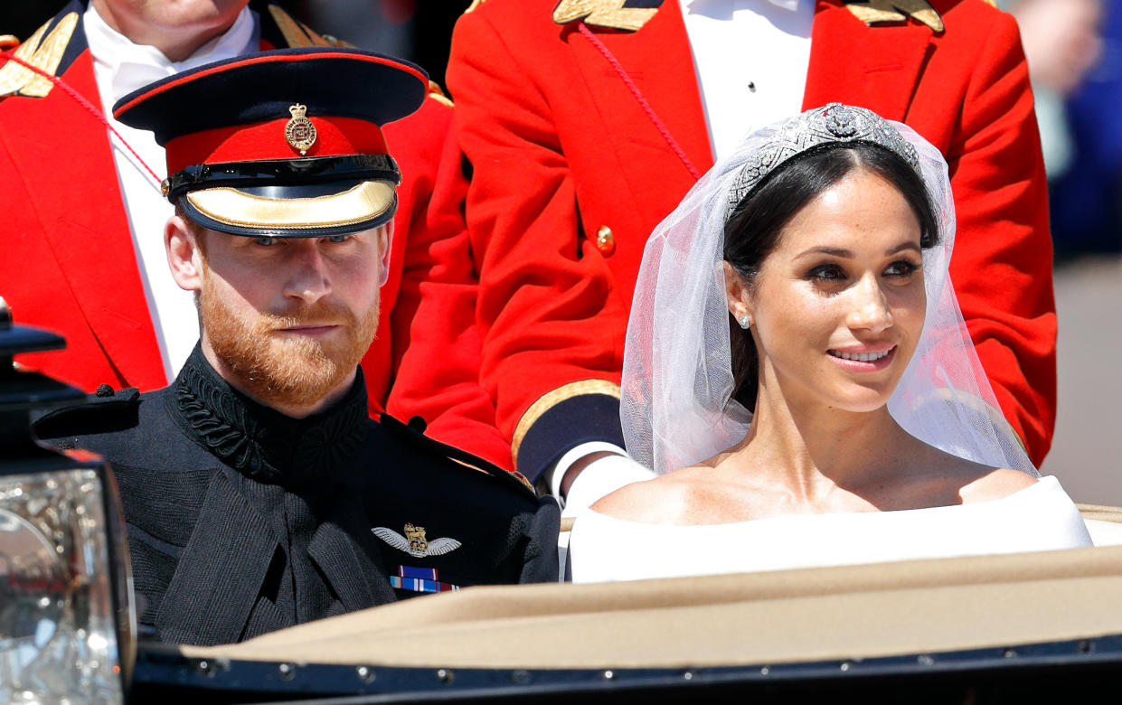 Harry and Meghan travel in an Ascot Landau carriage as they begin their procession through Windsor following their wedding at St George's Chapel, Windsor Castle on May 19, 2018 in Windsor, England. Prince Henry Charles Albert David of Wales marries Ms. Meghan Markle in a service at St George's Chapel inside the grounds of Windsor Castle. Among the guests were 2200 members of the public, the royal family and Ms. Markle's Mother Doria Ragland. (Photo by Max Mumby/Indigo/Getty Images)