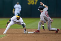 Boston Red Sox's Jarren Duran, right, steals second next to Oakland Athletics shortstop Darell Hernaiz during the second inning of a baseball game Monday, April 1, 2024, in Oakland, Calif. (AP Photo/Godofredo A. Vásquez)