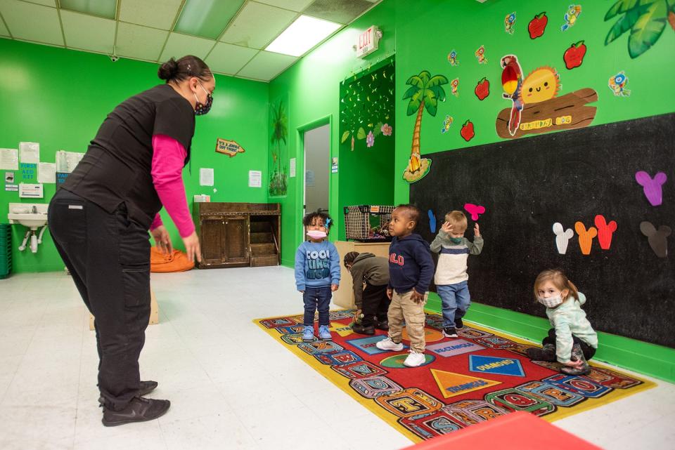 Chassity Delvalle, left, sings "heads shoulders knees and toes," with the toddler class at Victoria's Castle Daycare in New Windsor, Jan. 21, 2022.
