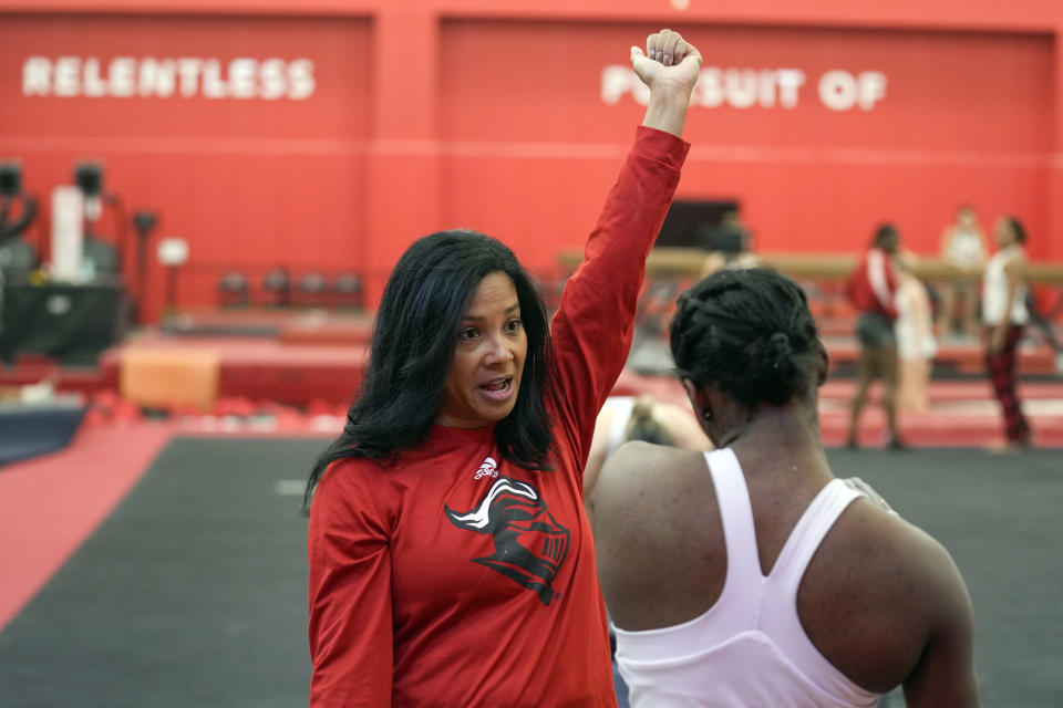 Rutgers women’s gymnastics coach Umme Salim-Beasley talks to a student athlete during a practice at Rutgers in Piscataway, N.J., Thursday, March 2, 2023. The Supreme Court's decision to overturn Roe v. Wade has added another complicated layer for college coaches to navigate. When the daughters of Salim-Beasley were making their list of potential college destinations, they crossed off states where abortions were sharply restricted. (AP Photo/Seth Wenig)