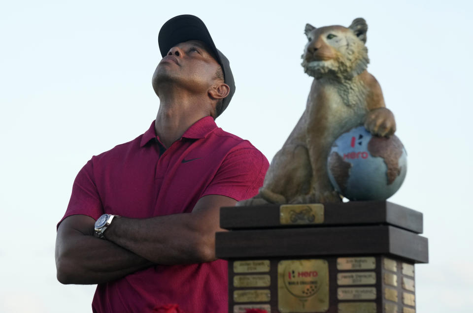 Tiger Woods stands next to the trophy after Norway,'s Viktor Hovland won the Hero World Challenge PGA Tour at the Albany Golf Club in New Providence, Bahamas, Sunday, Dec. 4, 2022. (AP Photo/Fernando Llano)