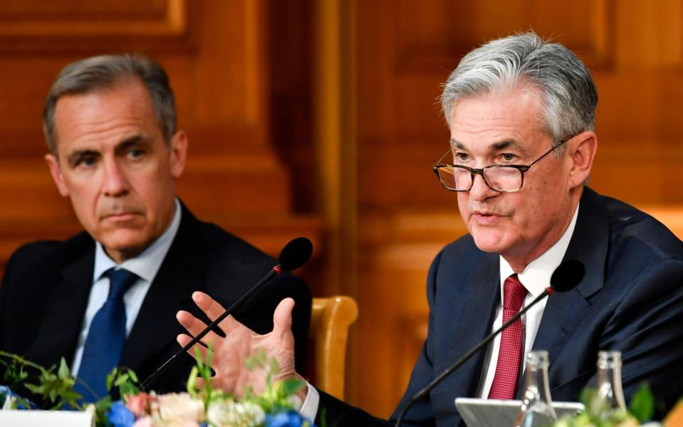 Jerome Powell, right, said central banks must be as transparent as possible to keep their legitimacy in the eyes of the public. Mark Carney, left, said introducing a new digital currency is not on the Bank of England's agenda for now - Bloomberg