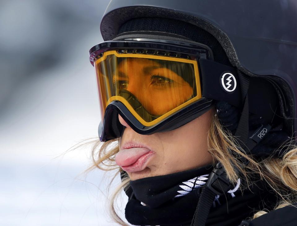 New Zealand's Rebecca Torr sticks out her tongue at the finish line during the women's snowboard slopestyle semi-finals at the 2014 Sochi Winter Olympics in Rosa Khutor, February 9, 2014. REUTERS/Mike Blake (RUSSIA - Tags: SPORT OLYMPICS SNOWBOARDING TPX IMAGES OF THE DAY)