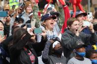 Fans cheer the 2021 World Series champion Atlanta Braves on Friday, Nov. 5, 2021, as the team parades up Cobb Parkway to Truist Park in Atlanta. (Steve Schaefer/Atlanta Journal-Constitution via AP)