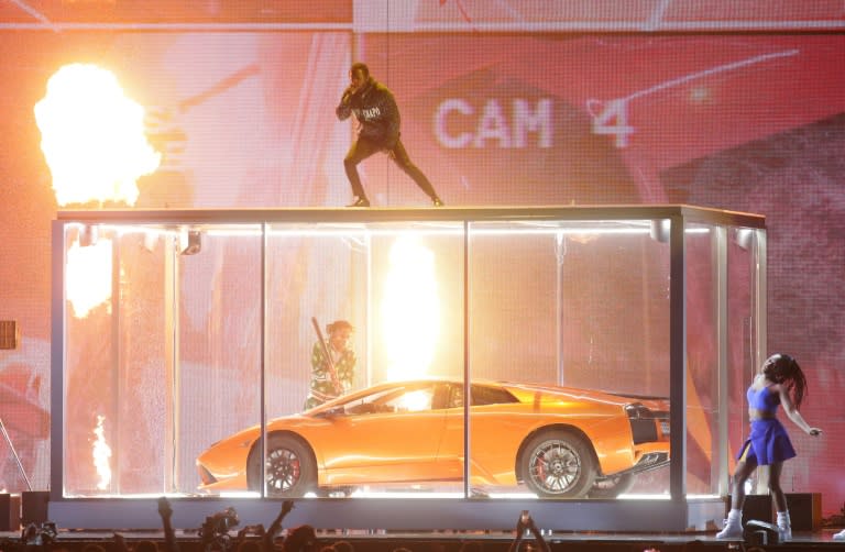 US rapper Kendrick Lamar performed live, standing on top of a huge box containing a sports car, which was smashed to pieces as the song went on