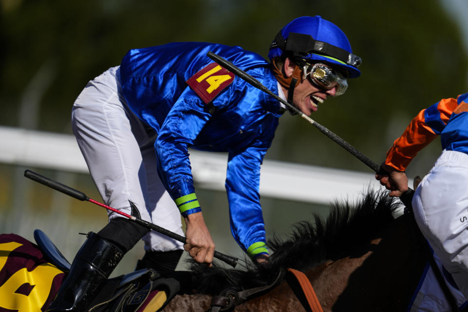 Tyler Gaffalione riding Pretty Mischievous celebrates after winning the 149th running of the Kentucky Oaks horse race at Churchill Downs Friday, May 5, 2023, in Louisville, Ky. (AP Photo/Julio Cortez)