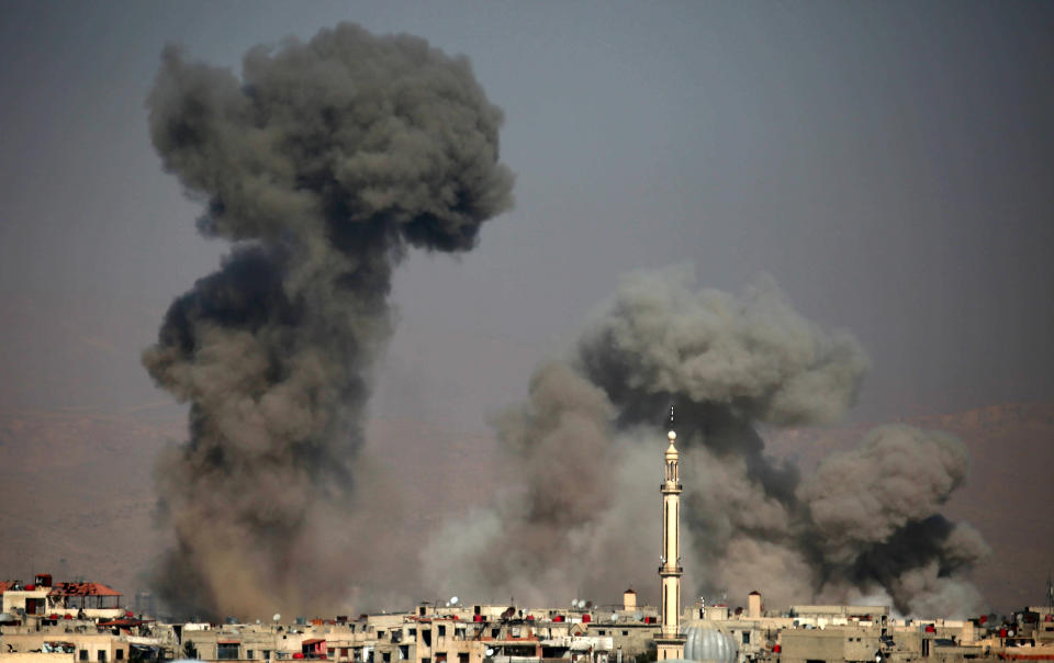 <p>Smoke plumes rise following a reported regime air strike in the rebel-held town of Arbin, in the besieged Eastern Ghouta region on the outskirts of the capital Damascus, Syria on Feb. 7, 2018. (Photo: Amer AlmohibanyAFP/Getty Images) </p>