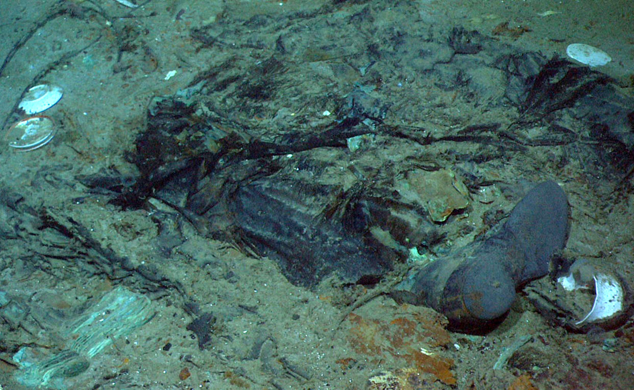 Image: The remains of a coat and boots buried in mud near the Titanic wreckage's stern in 2004. (Institute for Exploration, Center for Archaeological Oceanography / via AP file)