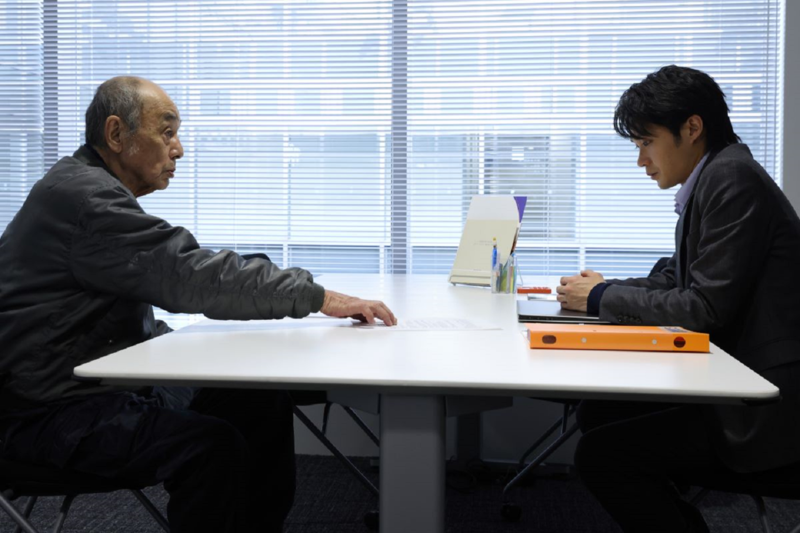 磯村勇斗（右）在《七五計劃》飾演承辦七五計劃的公務人員，卻因遇上親戚申請而有了遲疑。（天馬行空提供）