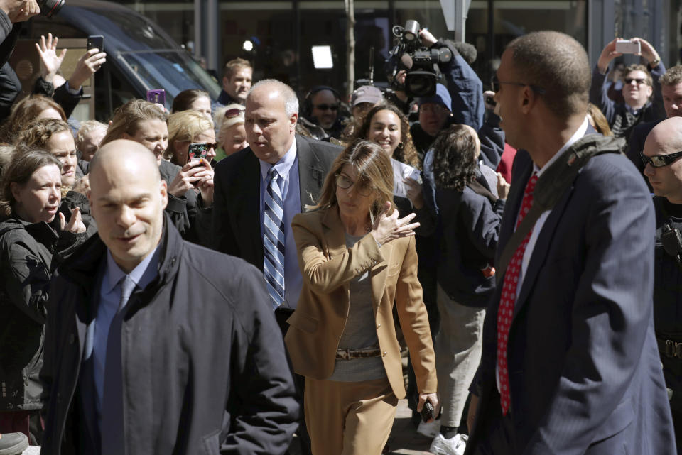 Fans photograph actress Lori Loughlin as she arrives at federal court in Boston on Wednesday, April 3, 2019, to face charges in a nationwide college admissions bribery scandal. (AP Photo/Charles Krupa)